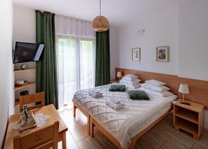 a bedroom with a bed and a large window at Cudne Manowce in Wisła