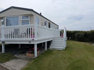 a house with a white deck and stairs at Ocean View in Aberaeron