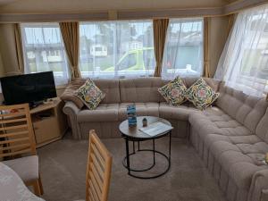a living room with a couch and a table at Ocean View in Aberaeron