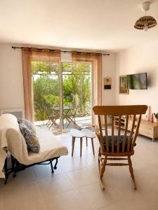 a living room with a chair and a window at L'oléastre en Luberon 2 in Grambois