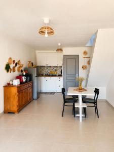 a kitchen and dining room with a table and chairs at L'oléastre en Luberon 2 in Grambois