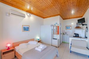 a bedroom with two beds and a kitchen in it at Matina Studios in Nikiana