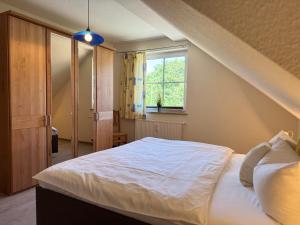 a bedroom with a large bed and a window at Altes Wasserwerk App 20 in Wustrow