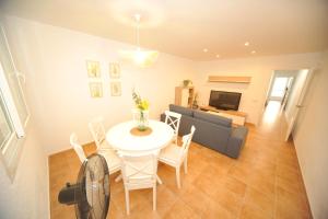 a living room with a white table and a couch at casa Bayer in Benicàssim