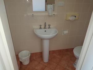 a bathroom with a sink and a toilet at Gateshead Tavern & Motel in Charlestown