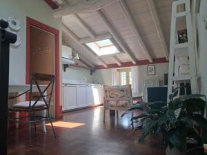 a kitchen with a table and chairs and a ladder at BoscoLago apartment Lake Iseo & Franciacorta in Iseo