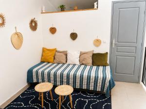 a room with a couch and two stools at L'oléastre en Luberon 2 in Grambois