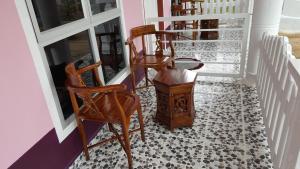 a room with chairs and a floor with a door at Iz Budget 2 in Kampung Kuala Besut