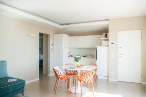 a kitchen and dining room with a table and chairs at Residence San Marco Suites&Apartments Alassio in Alassio