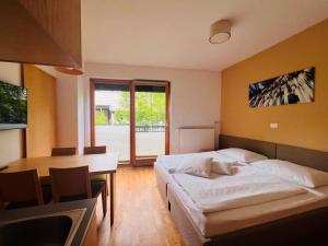 a bedroom with a bed and a desk and a table at Apartments and Rooms Bernik in Kranjska Gora +48 photos
