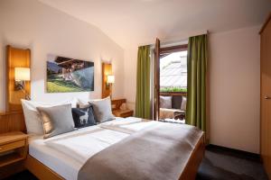 a hotel room with a large bed and a window at Apartment Anita in Westendorf +51 photos