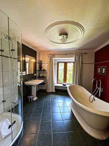 a large bathroom with a tub and a sink at Hotel Herrnschloesschen in Rothenburg ob der Tauber +44 photos