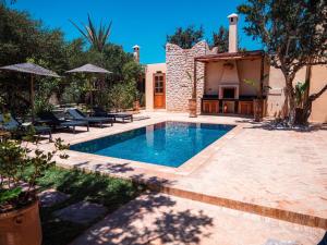 a swimming pool in the backyard of a house at Maison Zina in Al Ghar
