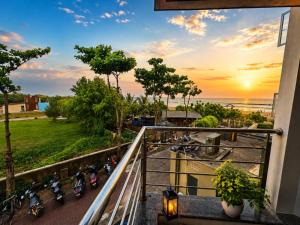 a balcony with a bunch of bikes parked next to the ocean at Golden Palace Puri - Private Flagship Beach - Swimming Pool - Sea View Rooms - Restaurant - Luxurious Stay in Puri