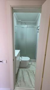 a bathroom with a shower and a toilet and a sink at Cottage in Bosteri +34 photos