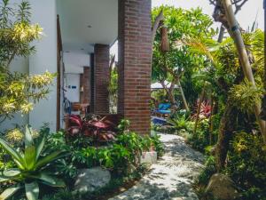 a garden in front of a house with plants at The Ambara Bali in Canggu