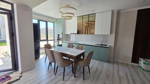 a dining room with a table and chairs in a kitchen at Cottage in Bosteri