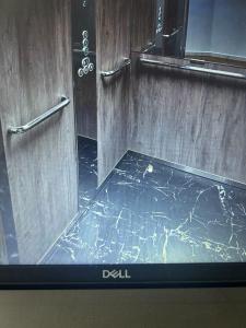 a television screen showing a bathroom with a marble floor at hugotel in Francescas