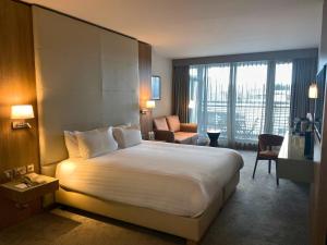 a hotel room with a large bed and a large window at Absolute Hotel Limerick in Limerick +50 photos