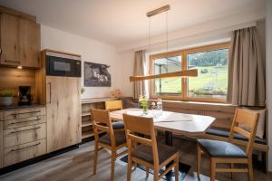 a kitchen and dining room with a table and chairs at Apartment Anita in Westendorf