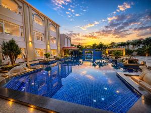 a large swimming pool in front of a building at Golden Palace Puri - Private Flagship Beach - Swimming Pool - Sea View Rooms - Restaurant - Luxurious Stay in Puri