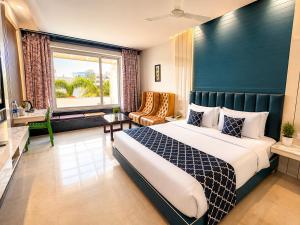 a bedroom with a bed and a large window at Golden Palace Puri - Private Flagship Beach - Swimming Pool - Sea View Rooms - Restaurant - Luxurious Stay in Puri +17 photos