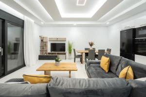 a living room with a couch and a table at Eagle's Nest - Adjoining Villas! in Tsilivi