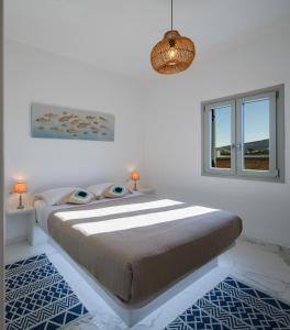a bedroom with a large bed and a window at Santana Apartments in Perivolos