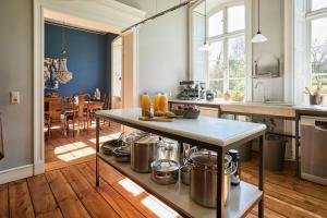 a kitchen with a table with pots and pans at Gut Pohnstorf in Alt Sührkow