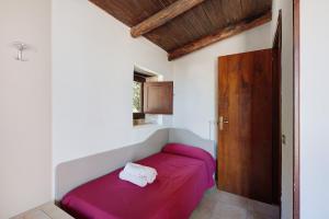 a small bedroom with a pink bed in a room at Tenuta Donna Carmela in Pisciotta +119 photos