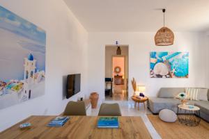 a living room with a couch and a table at Santana Apartments in Perivolos