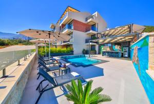 a villa with a swimming pool and a resort at Serenity Pearl in Kaş