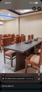 a conference room with a large table and chairs at Hotel Crown Plaza in Hoshiārpur +3 photos