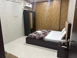a small bedroom with a bed and a tv at Hotel Crown Plaza in Hoshiārpur