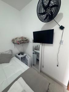 a bedroom with a bed and a fan on the wall at Ebeneze in Nova Friburgo