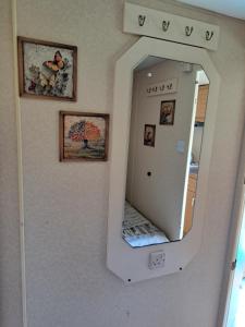 a mirror hanging on a wall in a room at Lini Guest House in Nīca +64 photos