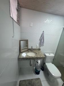 a bathroom with a sink and a toilet at Ebeneze in Nova Friburgo +3 photos