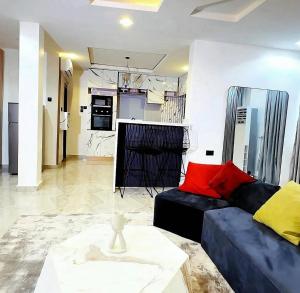 a living room with a couch and a table at OSOJAPA Residence in Asaba