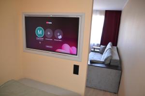 a room with a flat screen tv on a wall at Merķeļa apartamenti in Valka