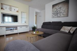 a living room with a couch and a table at Ana & Marija in Kaštela