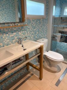 a bathroom with a sink and a toilet at Camping Bel Air - Cancale in Cancale +23 photos
