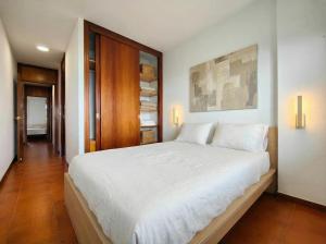 a bedroom with a large bed with white sheets at URB. PEDRAS NEGRAS in Pontevedra +12 photos