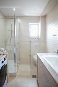 a bathroom with a shower toilet and a sink at Ana & Marija in Kaštela +55 photos