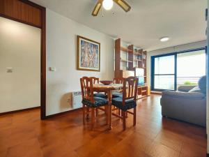 a living room with a table and chairs and a couch at URB. PEDRAS NEGRAS in Pontevedra