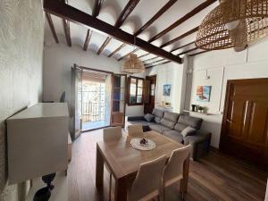 a living room with a table and a couch at Cal Padrí in Caseras