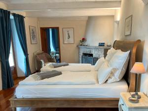 a bedroom with two beds and a fireplace at Villa Zanotti in Cannero Riviera +17 photos