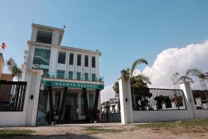 a building with a sign that reads miami greens at Hotel Maurya Greens in Banbāsa