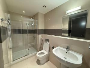 a bathroom with a toilet and a sink and a shower at Thewalk2 Pool View ~ 5 mins from Airport in Seeb