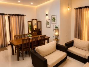 a living room with a table and a dining room at Eighty seven guest and restaurant in Badulla