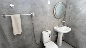 a bathroom with a toilet and a sink and a mirror at Eighty seven guest and restaurant in Badulla +48 photos